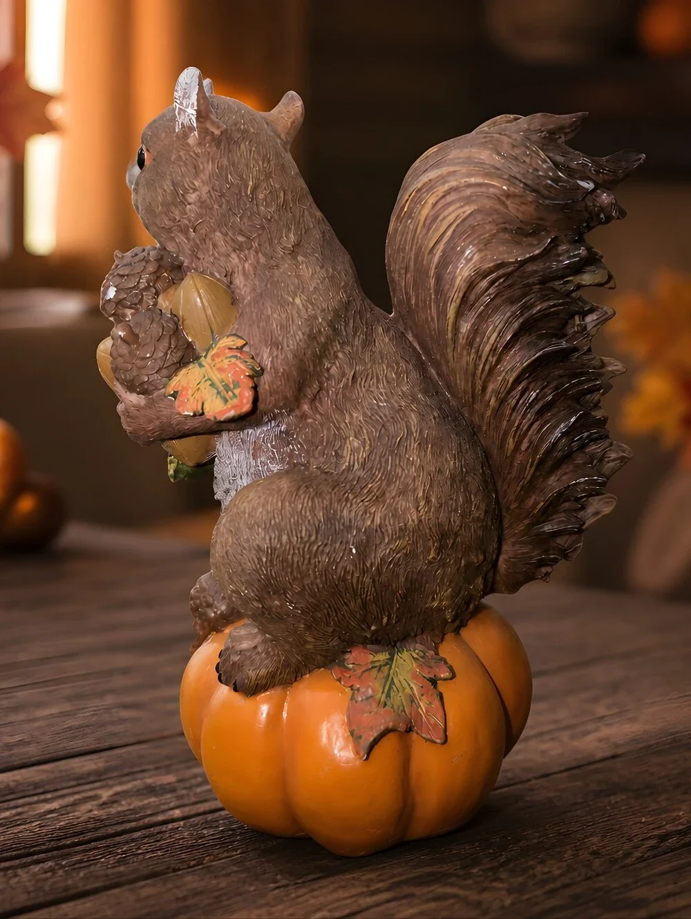 vintage resin autumn squirrel figurine perched atop a pumpkin Holdinging Nuts